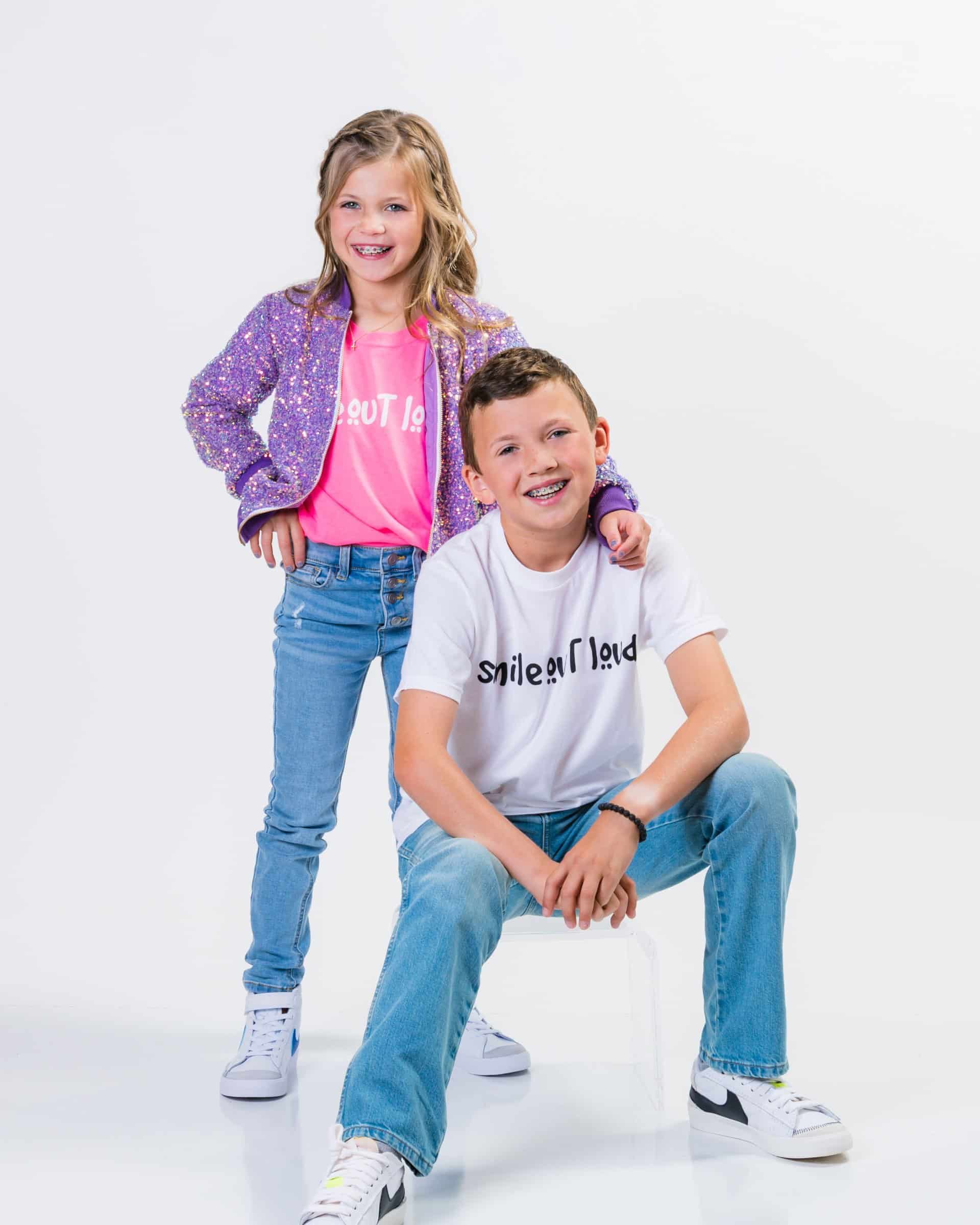 A man and a young girl smiling at the camera. | Harwell & Cook Orthodontics