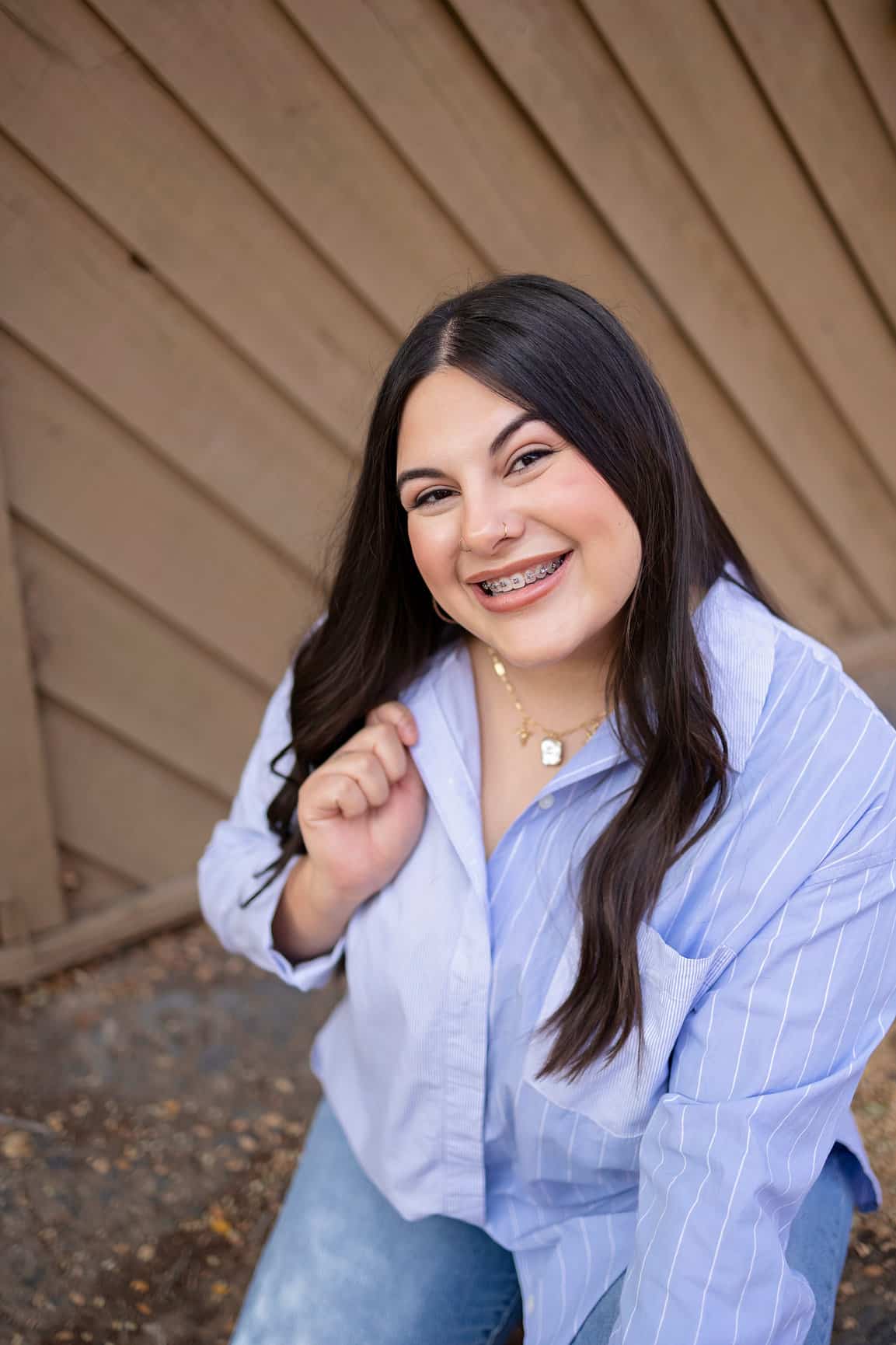 A young woman with braces making a friendly gesture. | Harwell & Cook