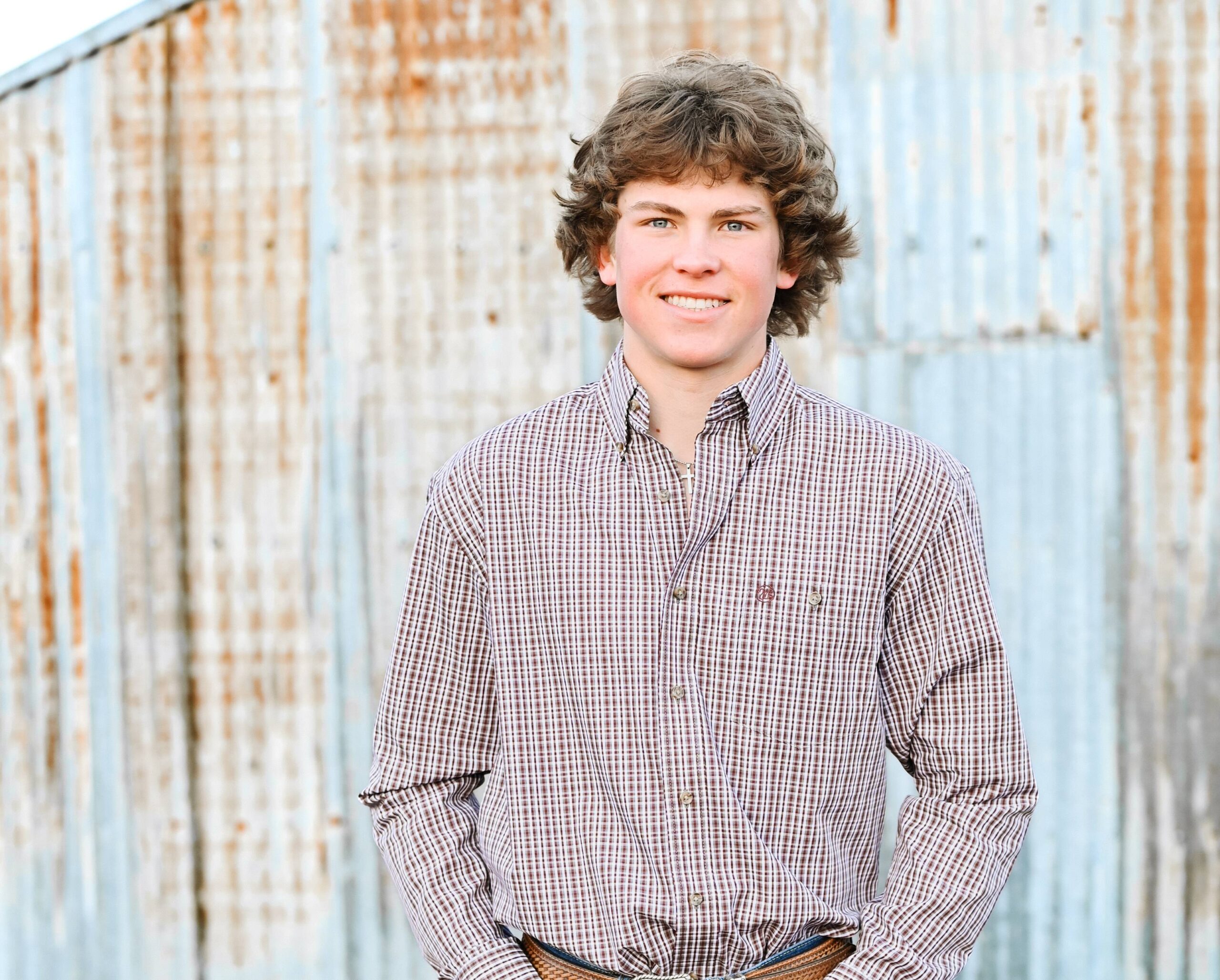 A young man in a flannel shirt. | Harwell & Cook Orthodontics