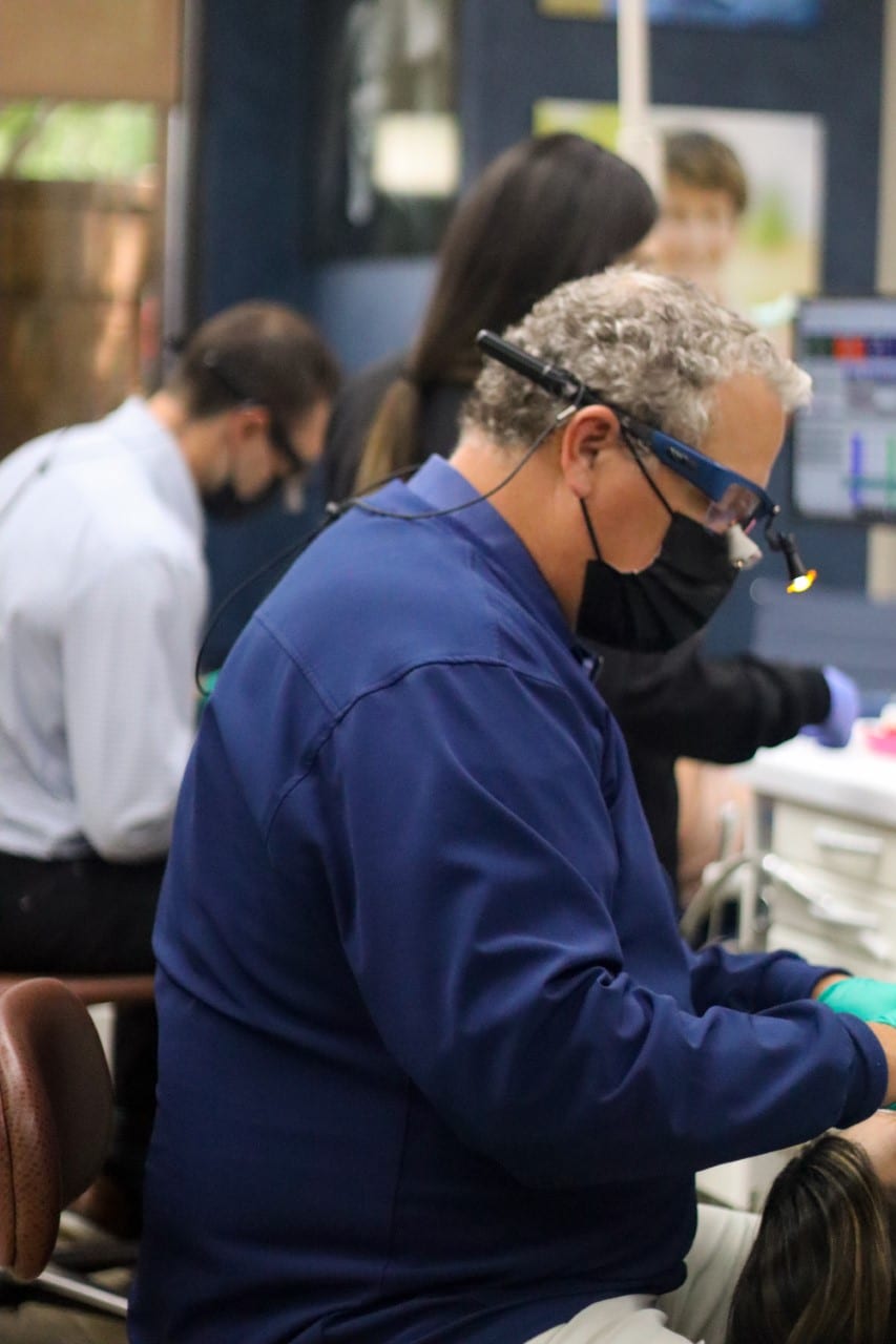 An orthodontist working with dental equipment. | Harwell & Cook Orthodontics