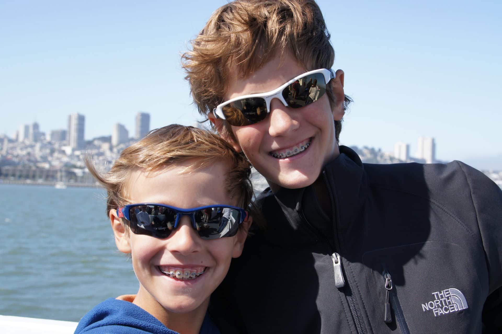 Two young boys posing together outdoors. | Harwell & Cook Orthodontics