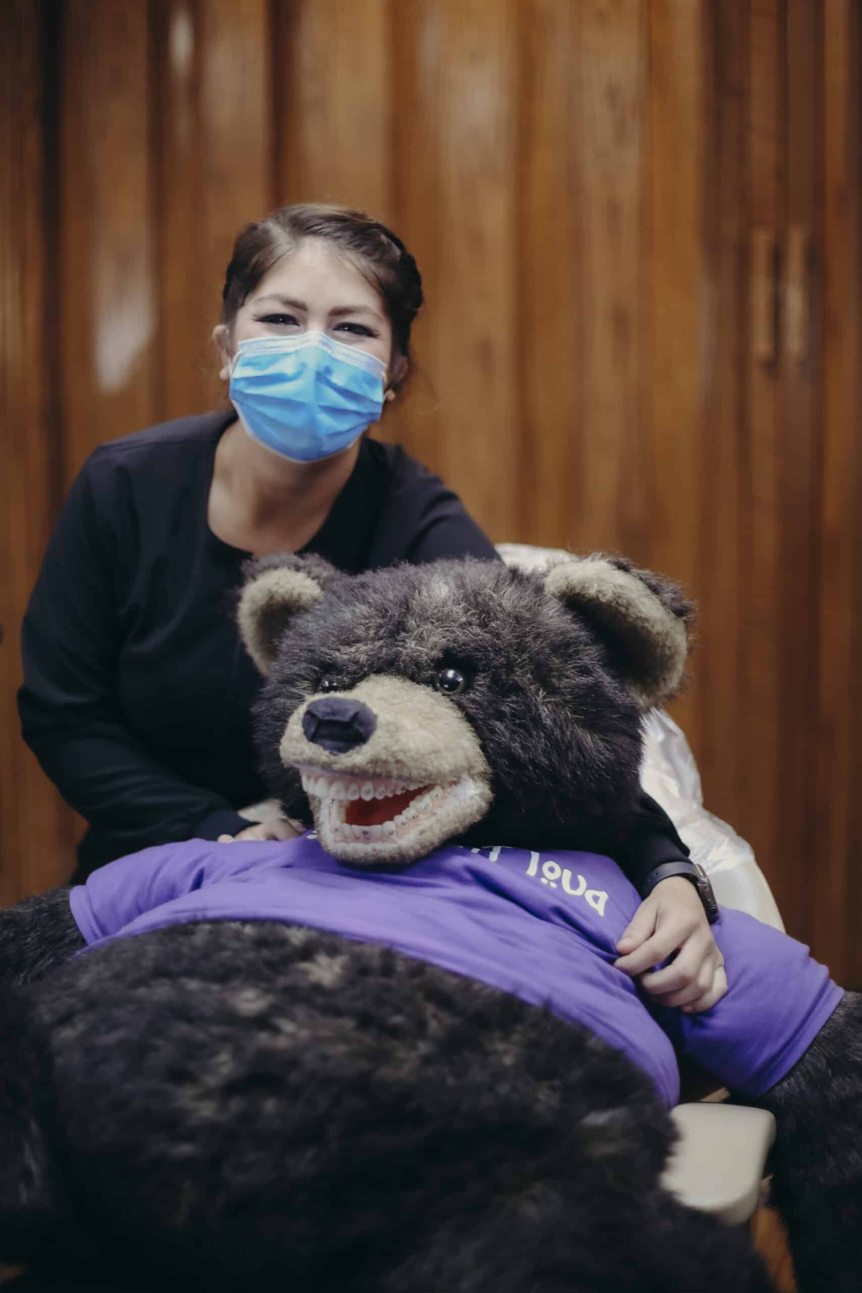 A team member with a bear mascot. | Harwell & Cook Orthodontics