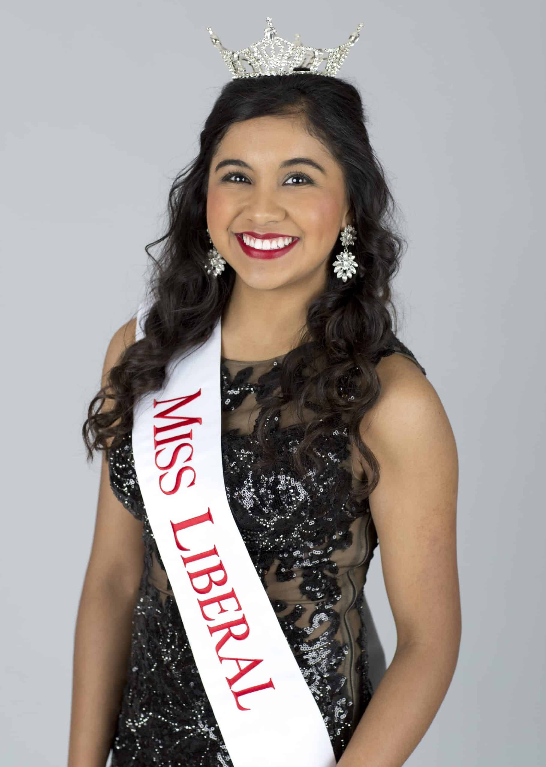 A young woman with a crown and a pageant sash. | Harwell & Cook Orthodontics